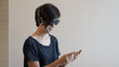 © glowonconcept - Asian woman lifestyle using smartphone while using headphones and wearing eyeglasses