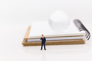 Miniature people : Businessman with book. Image use for business concept.