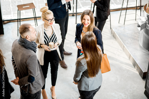 Photographie Business people having a conversation during the coffee break standing in the ca