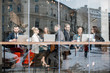 © rh2010 - Business people during the coffee break sitting with laptops near the window. View through the window with city reflection
