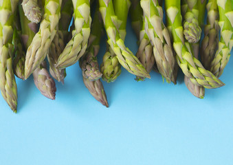 Poster - Fresh  raw asparagus on light blue background, copy space