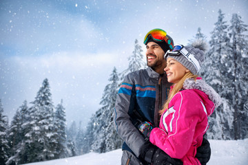 Wall Mural - couple enjoying on winter hill and looking away