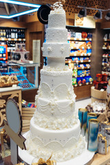 Wedding cake decorated with flowers in bakery