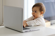 © Tetiana Soares - Little baby curiously looking at laptop with open mouth, surprised, child and computer concept