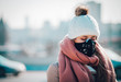 © leszekglasner - Young woman wearing protective mask in the city street, smog and air pollution