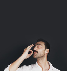 Young handsome man with beard and mustache studio portrait