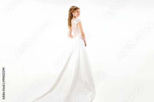 Young Blonde Girl In A White Wedding Dress And Jewelry In
