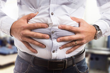 Man Pressing Bloated Abdomen Or Belly As Cramp Flatulence Problem.