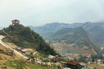 Step ladder farm on the hill with villages and mountain in the background in summer in the morning in Sa Pa, Vietnam.