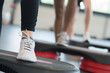 © auremar - close up of feet on step during exercise class