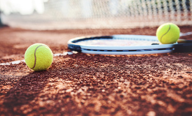 Tennis ball with racket on the tennis court. Sport, recreation concept