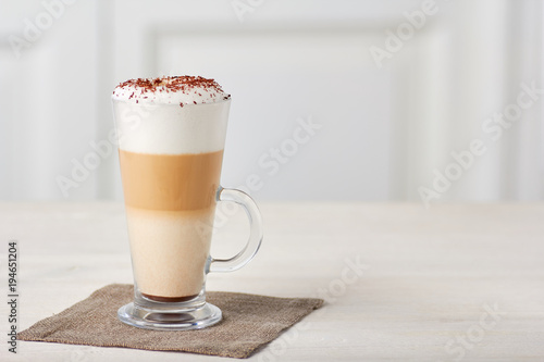 Glass cup of coffee latte on wooden table Tableau sur Toile