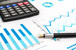 © igorkol_ter - Pen with calculator on the financial graphs. Business concept.