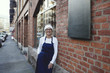 © Maskot - Portrait of mature woman wearing apron