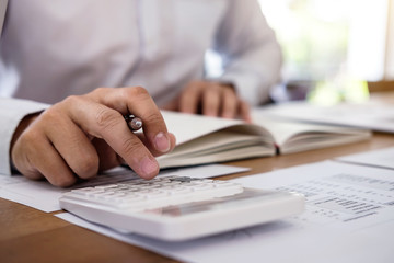 Fototapete - Professional businessman working with calculator, Doing finance on laptop, document graph and analysis business strategy to development profit