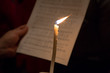 Single candle against sheet music