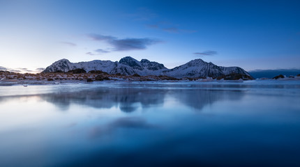 Wall Mural - Mountain ridge and reflection in the lake. Natural landscape in the Norway