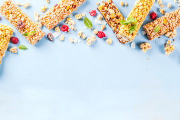 Healthy breakfast and snack concept, homemade granola with fresh raspberries and nuts and granola bars, on bright blue background copy space seamless pattern top view