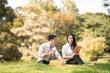 © ic36006 - Selective focus business couple relaxing with tablets in park after work done