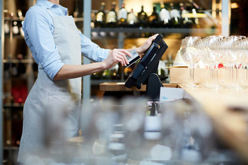 Close-up of waitress registrating orders at the cash desk