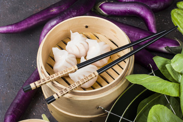 Dim sum dumplings in steamer with traditional chinese vegetables