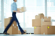 © pressmaster - Blurry motion of businessman carrying boxes from one office to another during relocation