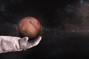 Wall Mural - mars in the hands of astronaut. elements of this image furnished by nasa.