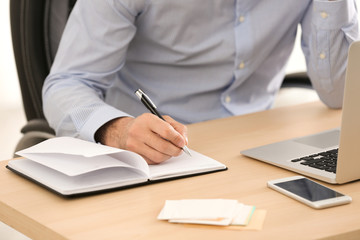 Canvas Print - Man working at table in office, closeup