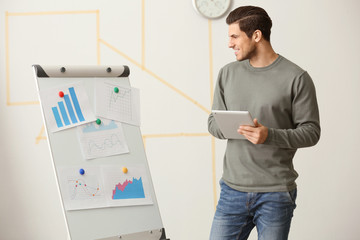 Canvas Print - Young man working in office