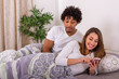 © Marko - Jealous boyfriend looking at girlfriends phone in the bedroom