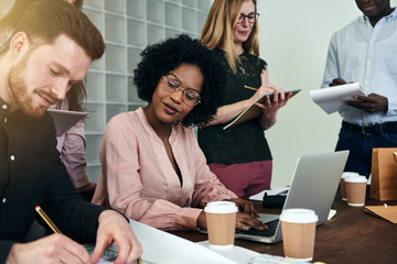 African businesswoman working with colleagues in an office