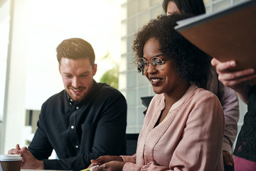 Wall Mural - Diverse group of colleagues working together at an office desk