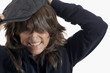 © Pamela Au - Middle Aged Woman with Brown Hair putting on a Derby Cap