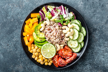 Sticker - Vegetarian salad Buddha bowl dish with brown rice, avocado, pepper, tomato, cucumber, chickpea, chia seeds, fresh lettuce salad and cashew nuts. Healthy eating trend, superfood. Top view