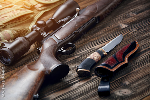 Photographie Hunting equipment on old wooden background.