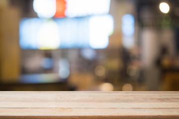 Wall Mural - Empty wood table with night cafe blur background.