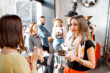 Young friends dressed casually have fun spending time in the beautiful cafe