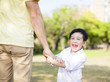 © Tom Wang - father holds the hand of little boy