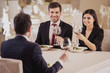 © Vadym Huzhva - Business lunch. Team meeting in restaurant, eating and drinking in celebration of good work together