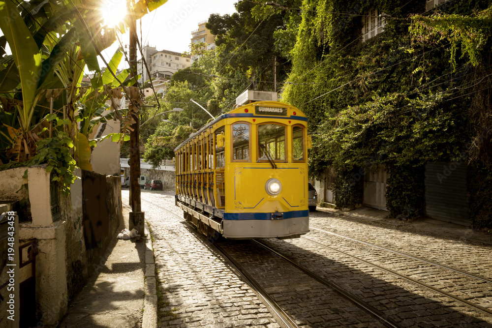 Old yellow tram in Santa Teresa district in Rio de Janeiro, Brazil - obrazy, fototapety, plakaty 
