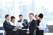 © ASDF - businessman and his business team with financial documents sitting at a Desk in the lobby of the Bank.