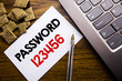 © Artur - Handwriting Announcement text showing Password 123456. Business concept for Security Internet written on sticky note paper on the wooden background next to the laptop keyboard