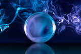 Fototapeta  - crystal ball in a dark blue smoky background