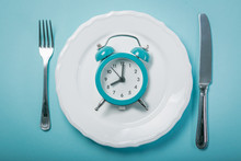 Intermittent Fastin Concept - Empty Plate On Blue Background