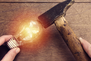 woman hand doing maintenance of small lamp lighting  