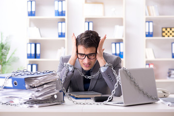 Busy employee chained to his office desk