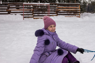 the teenager plays on the street in the winter