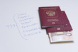 © Александр Овсянников - Russian passport with euro banknotes on a white sheet with inscriptions of European countries. Planning your trip on vacation.