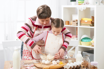 Mother and daughter cook at home. Kitchen interior, healthy food concept