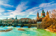 View on winter landscape by turquoise Isar and St. Anna church in Munich